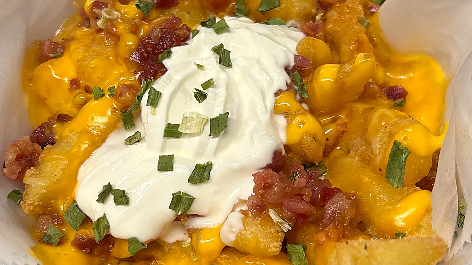 Loaded fries with cheddar, sour cream, bacon and chives